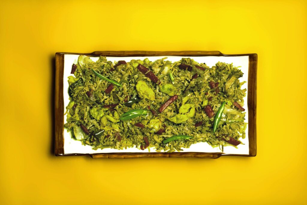Delicious Asian vegetable rice dish presented on a vibrant yellow background, perfect for food photography.